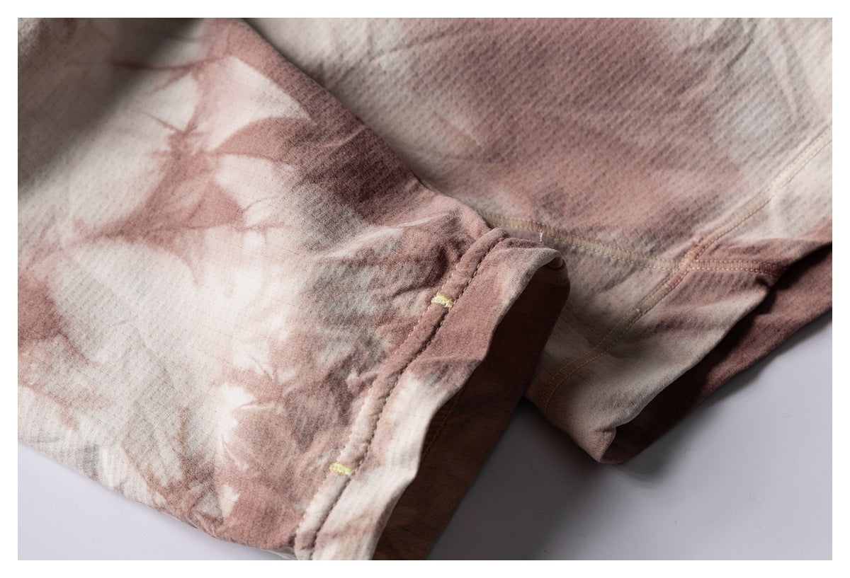 Close-up of a sleeve cuff and seam on the cream and dusty-rose patterned shirt.