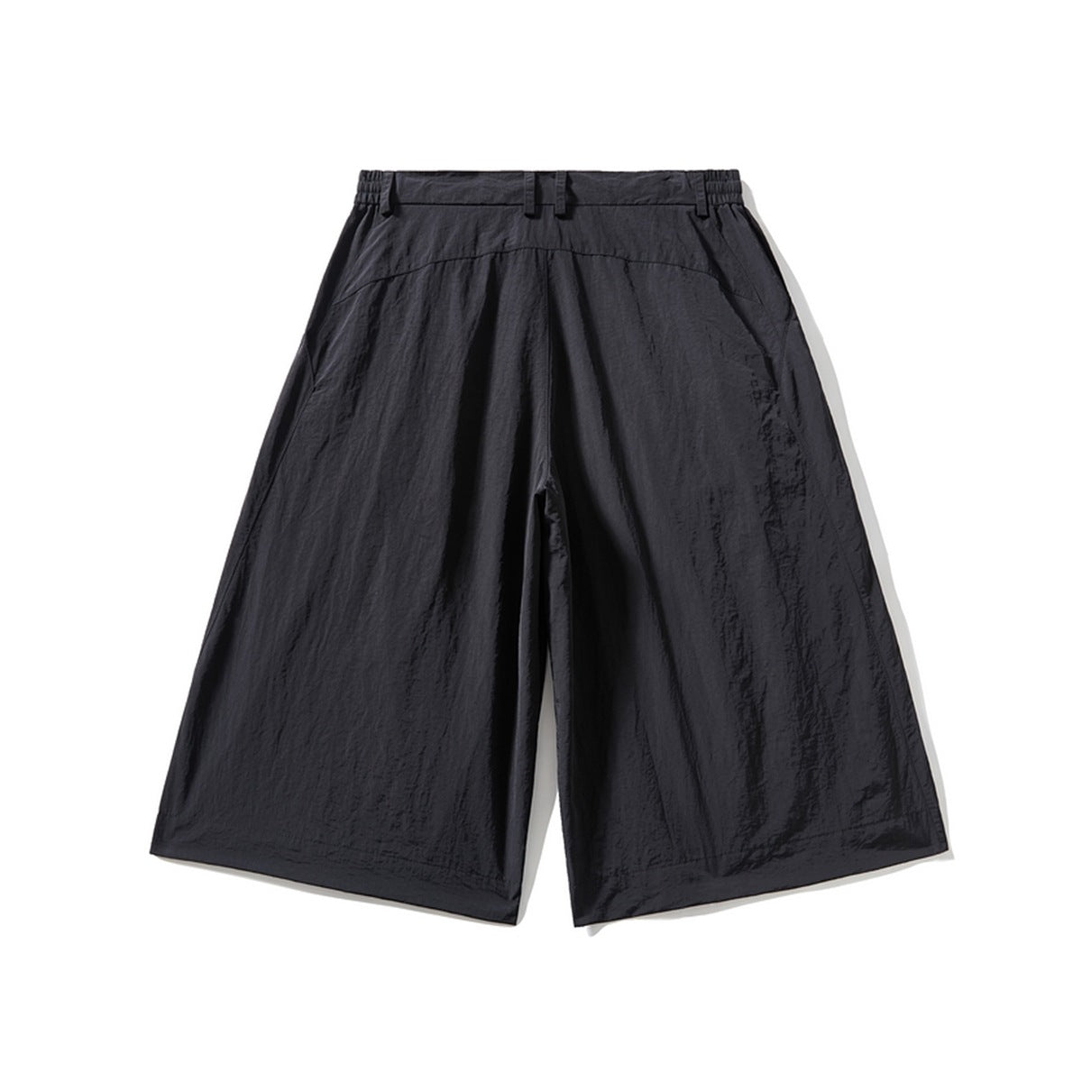 Back view of black wide-leg knee-length shorts with elastic waistband, belt loops and back yoke seam