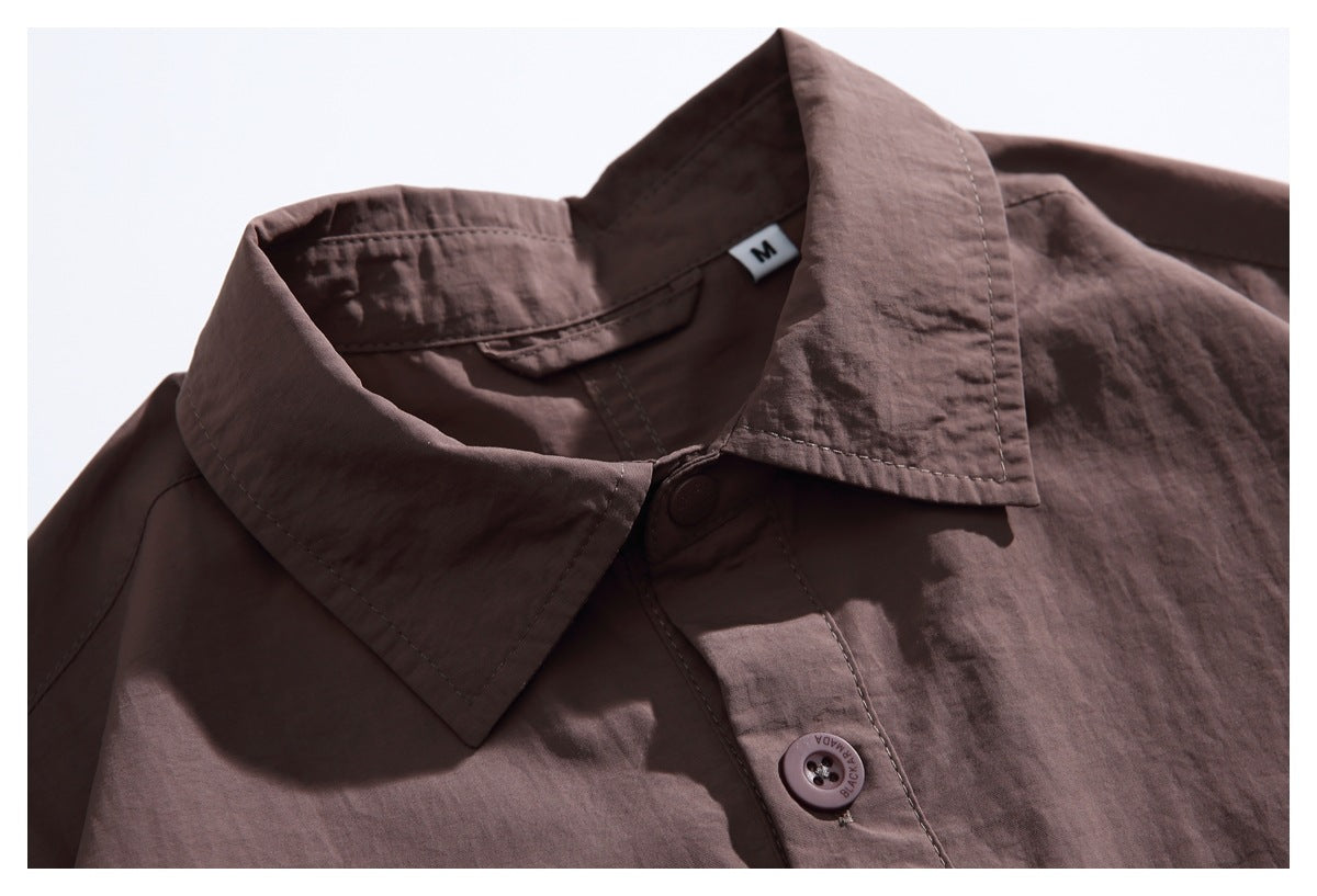 Close-up of a muted brown shirt collar, button placket, and size label.