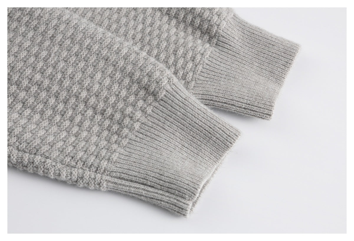 Close-up of the light gray cardigan's textured knit and ribbed sleeve cuffs.
