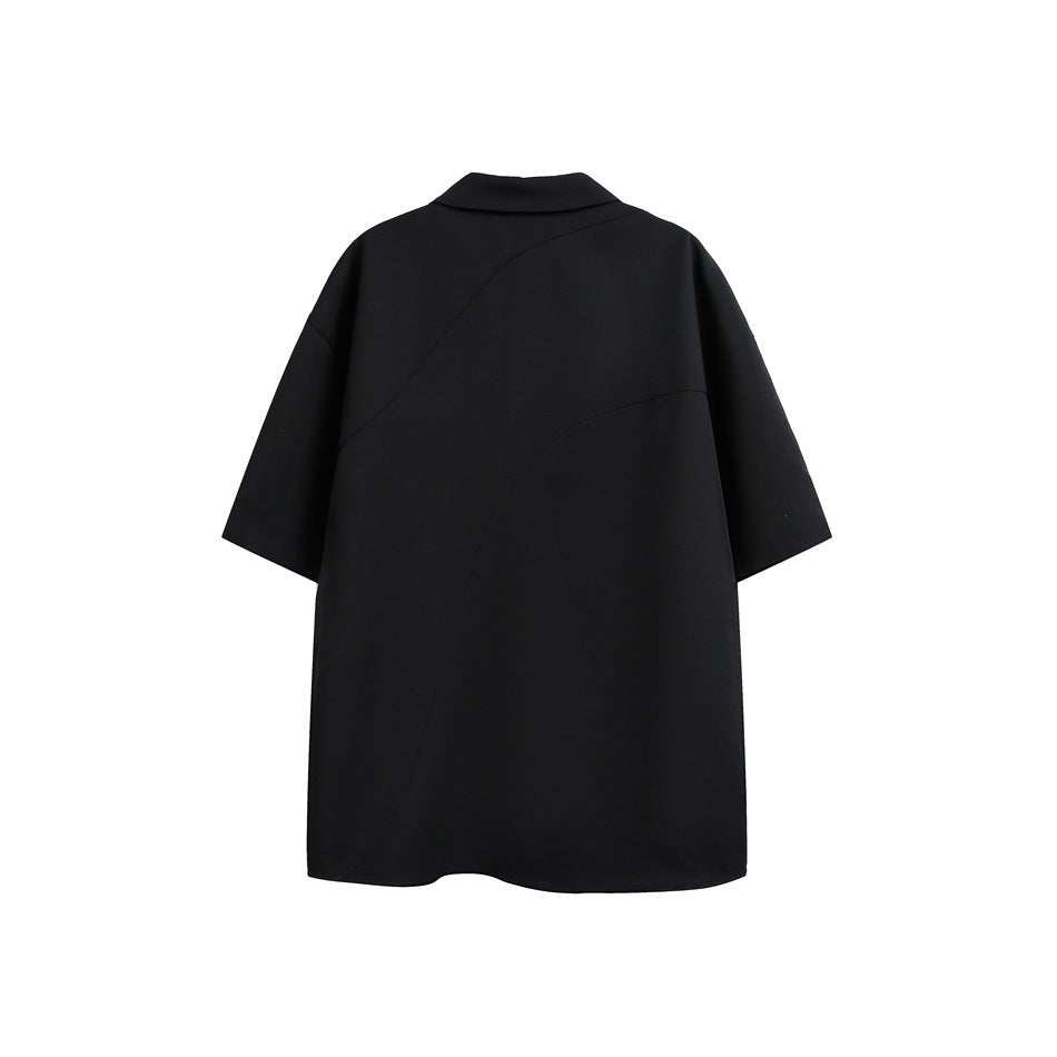 Back view of a black short-sleeve shirt with a pointed collar and curved panel seams.