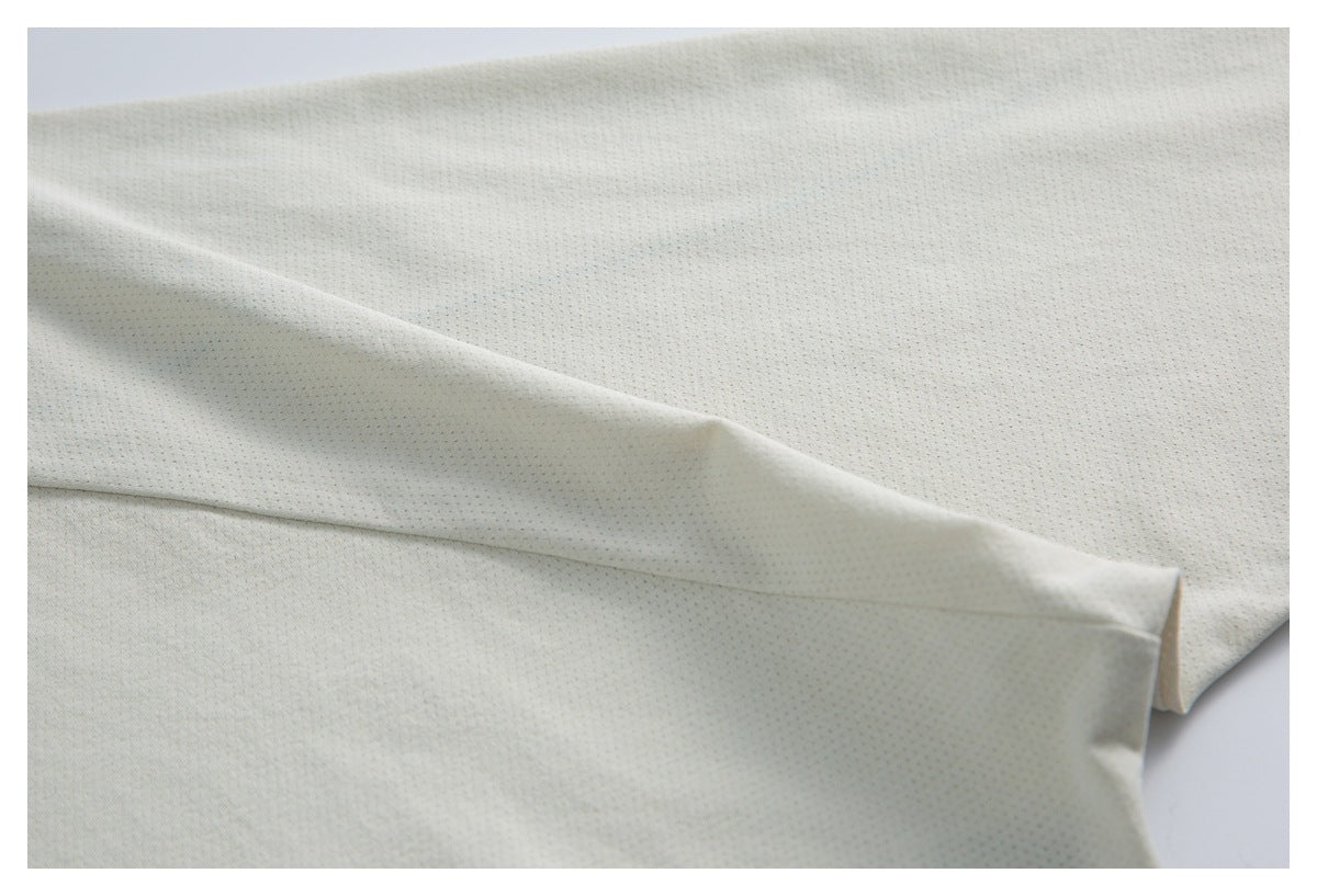 Close-up of the ivory top's perforated fabric, showing a folded section and stitching.
