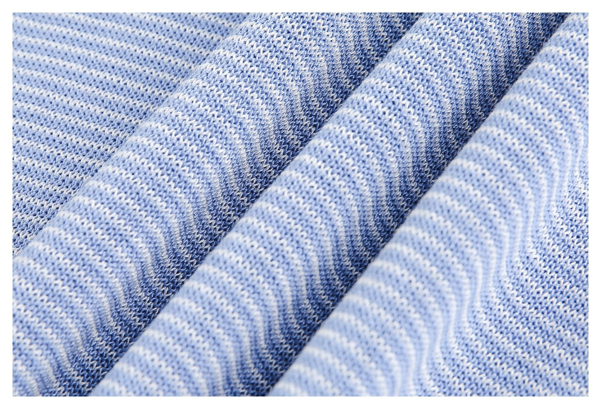 Close-up of blue-and-white heathered knit fabric gathered into soft folds.
