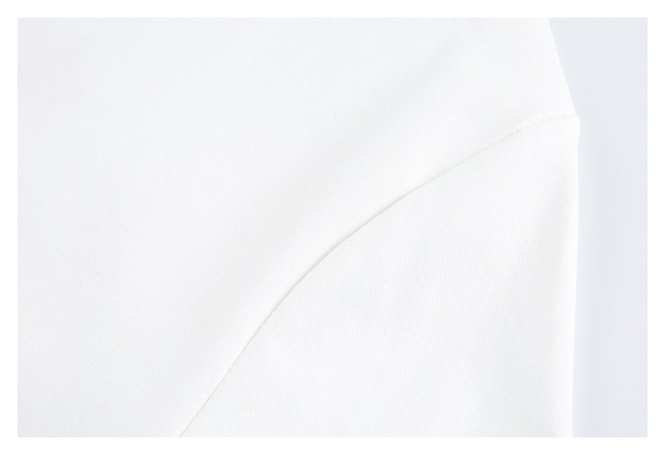Close-up of a curved seam joining panels of white garment fabric.