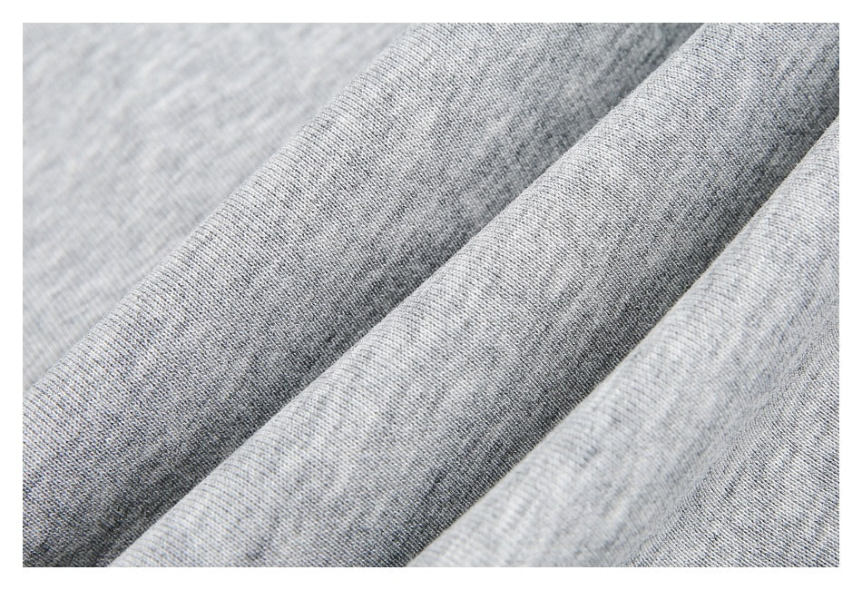 Close-up of the light gray garment's knit texture in soft folds.