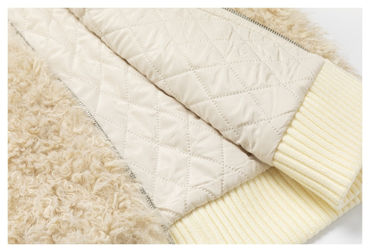 Close-up showing the jacket's cream diamond-quilted lining, curly fleece, zipper, and ribbed cuff.