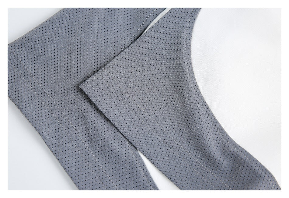 Close-up of overlapping gray perforated mesh panels and their stitched seams.