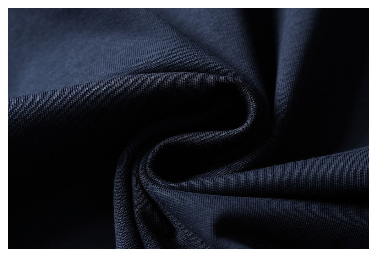Close-up of dark navy fabric draped to show its knit texture and folds.