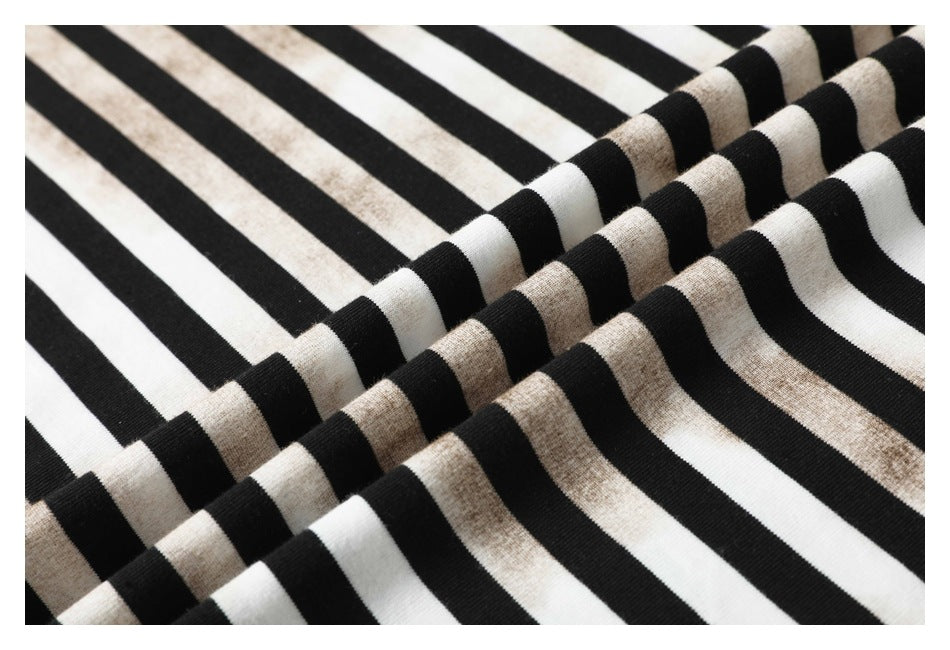 Close-up of black-and-white striped fabric arranged in soft folds.