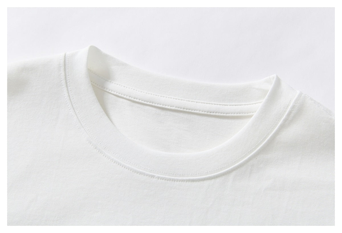 Close-up of the white T-shirt's crew neckline, ribbed collar, and stitching.