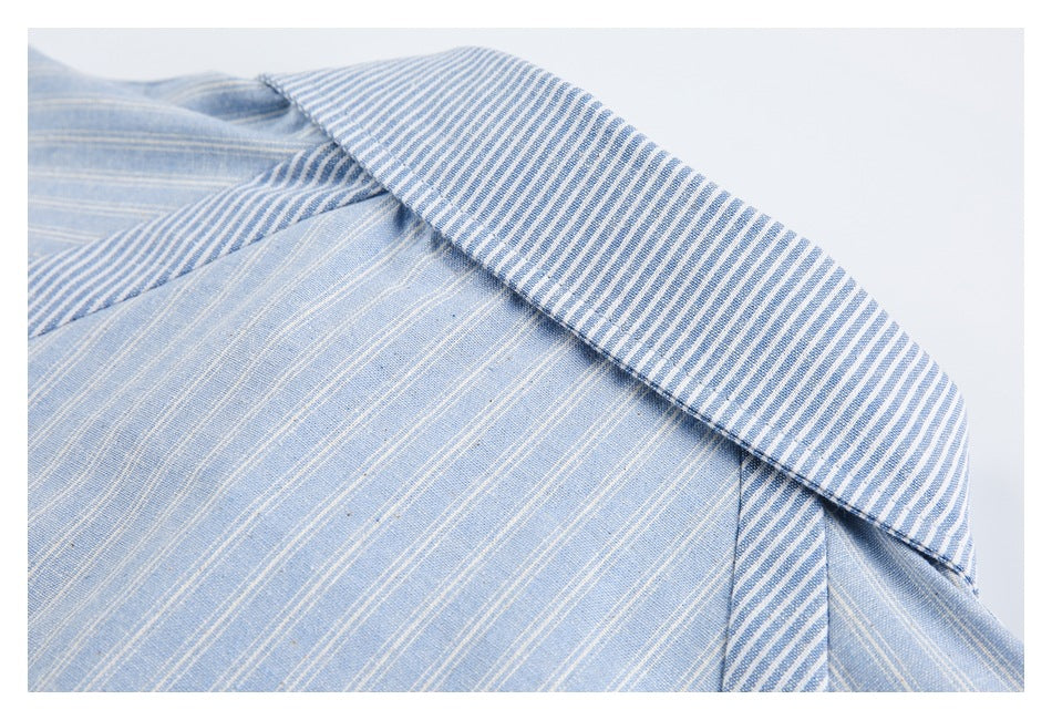 Close-up of a blue-and-white striped shirt collar over a lighter blue pinstriped body.