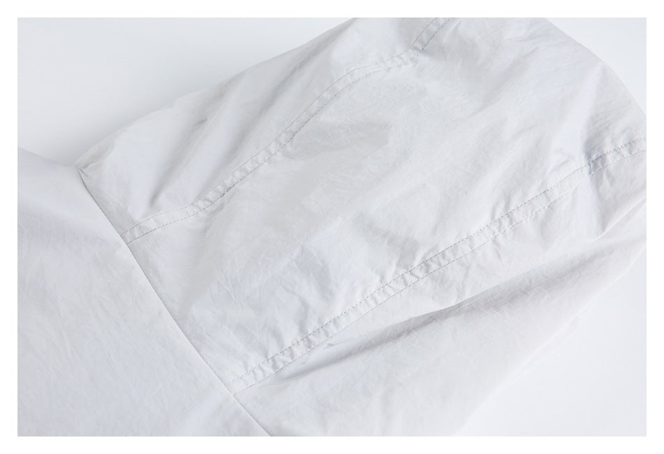Close-up of a rectangular stitched panel on light gray fabric.