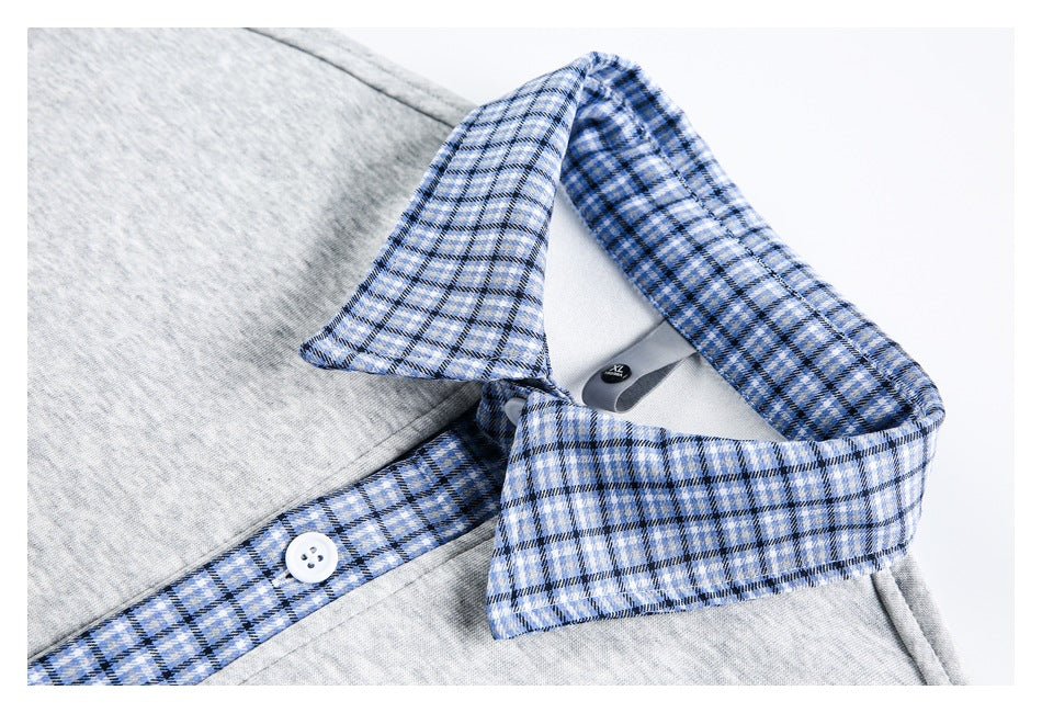 Close-up of a gray top's blue plaid collar, button placket, and inner neck label.