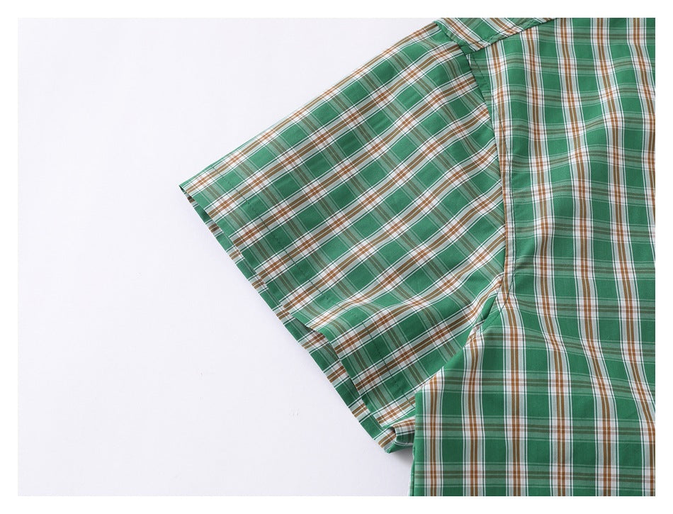 Close-up of the green plaid shirt's short sleeve and side seam.