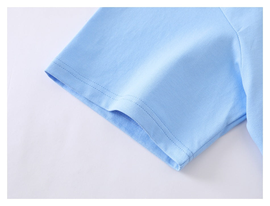 Close-up of the light blue T-shirt sleeve hem showing double stitching and the shoulder seam.