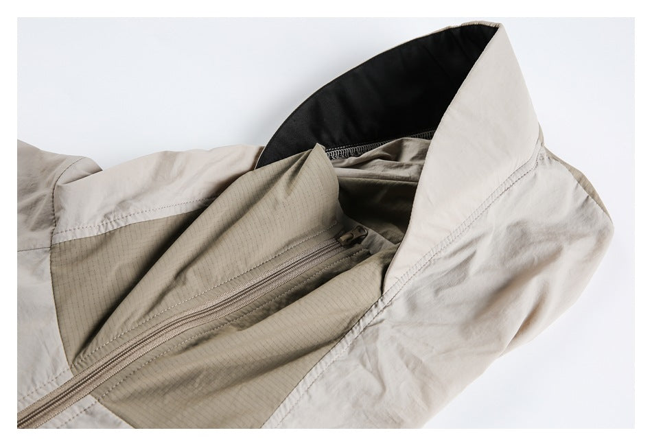 Close-up of a light beige jacket collar, dark lining, and diagonal zipper panel.