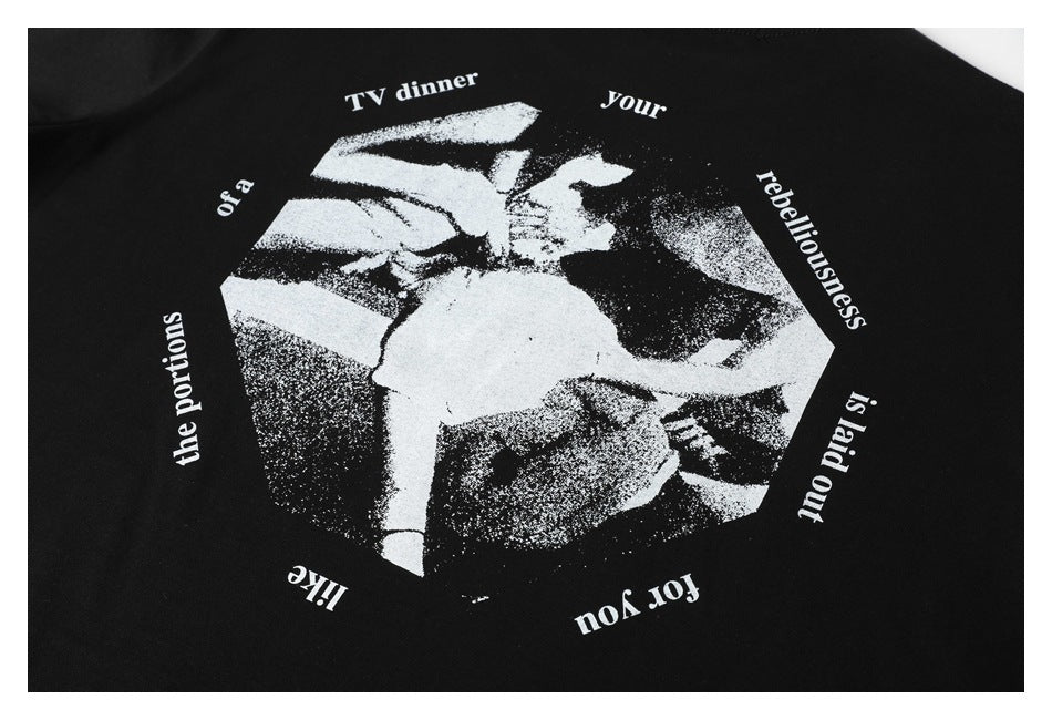 Close-up of a white graphic and English lettering printed on black T-shirt fabric.