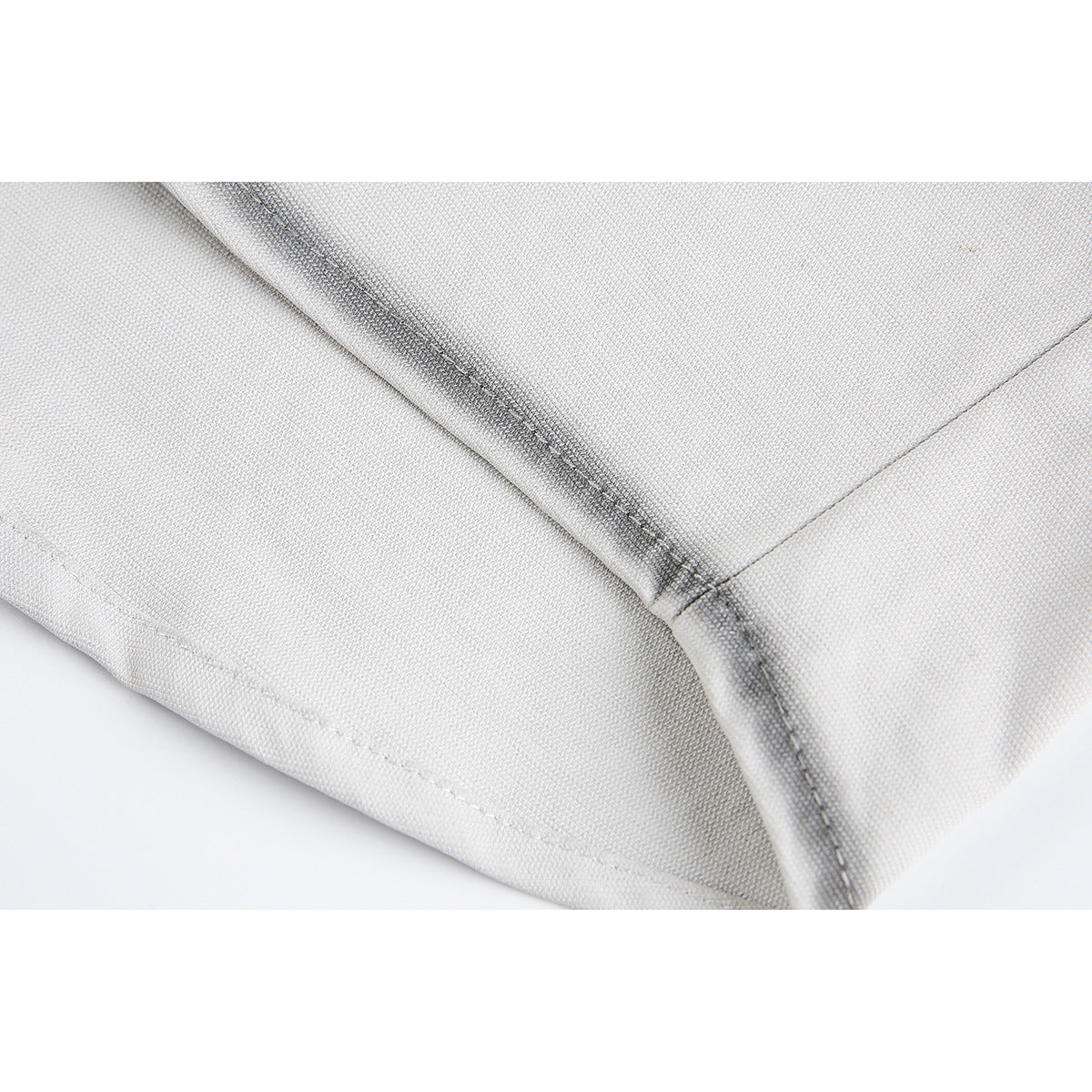Close-up of the light gray shirt's dark-edged seam and hem stitching.