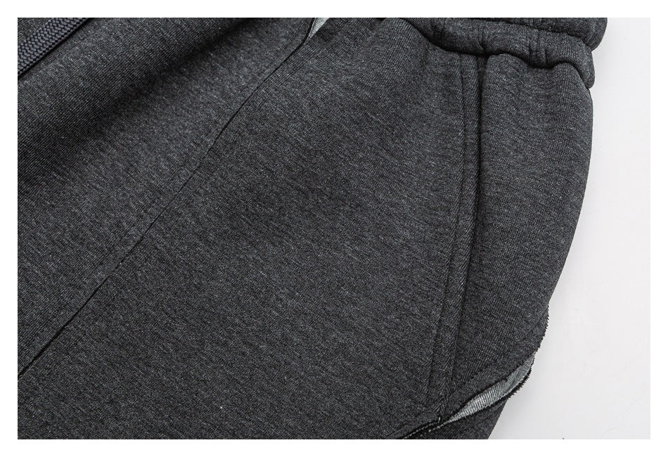 Close-up of charcoal gray jogger pants showing a side pocket and stitched seams.
