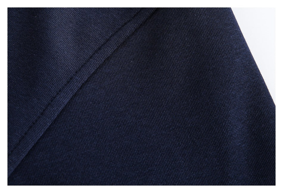 Close-up of navy fabric with a diagonal stitched seam.