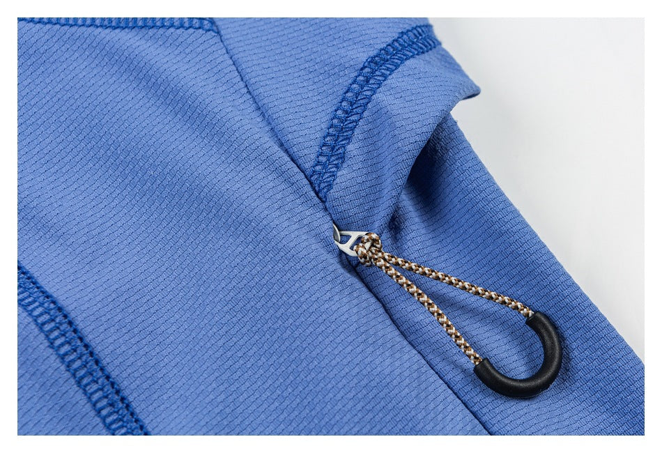 Close-up of a braided drawcord with a black hook-shaped toggle on blue fabric.
