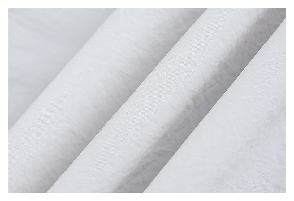 Close-up showing the lightly textured surface and folds of light gray fabric.