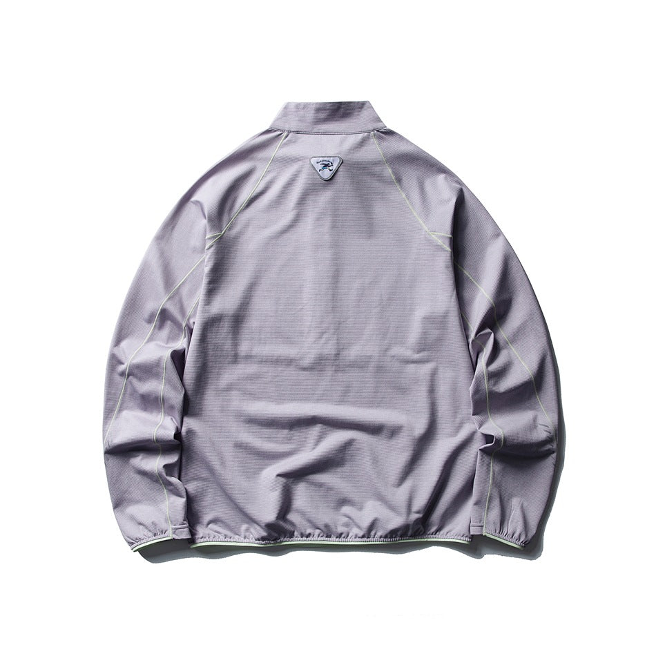 Back view of a lavender high-collar jacket with pale green seam piping, elastic cuffs and hem, and a small shield patch.