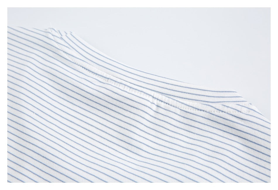 Close-up of the back neckline seam on a white shirt with thin blue stripes.