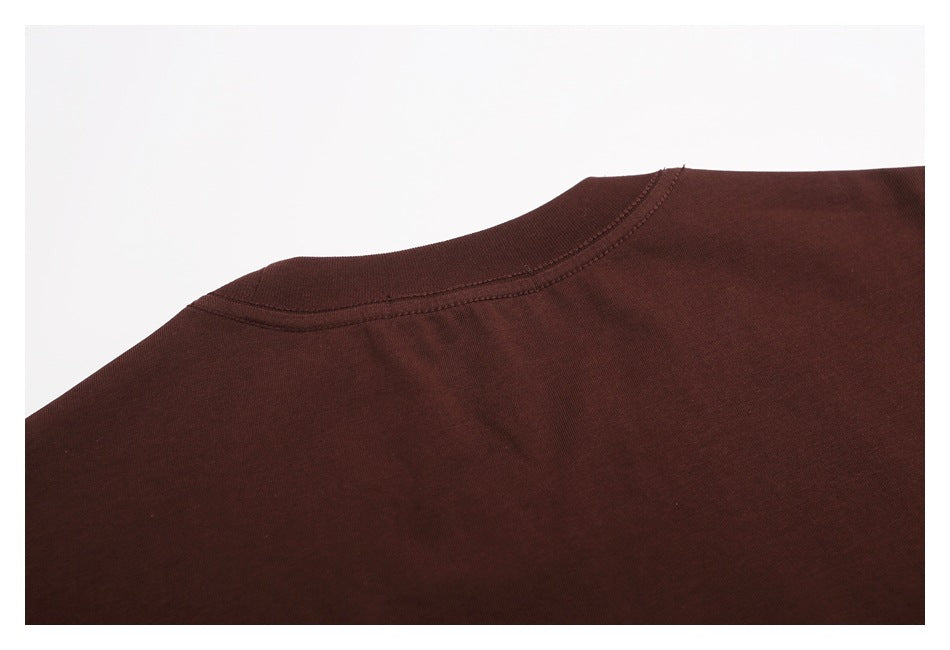 Close-up of the dark burgundy-brown garment’s rounded neckline and stitching.