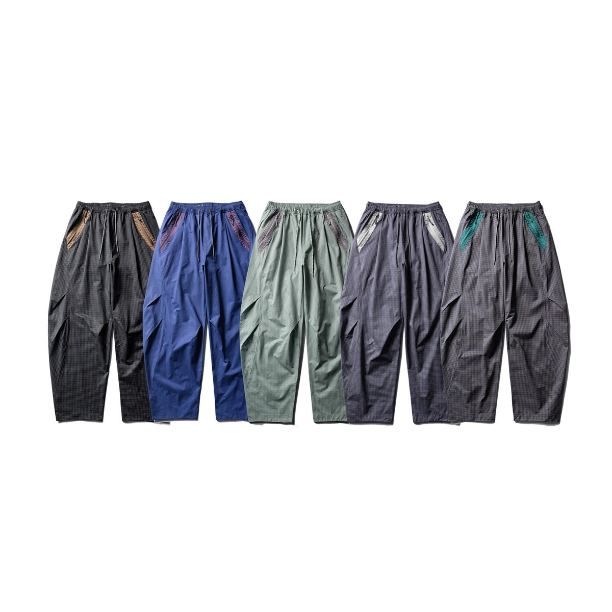 Five pairs of loose pants shown from the front in black, blue, sage, charcoal, and dark gray plaid colorways.