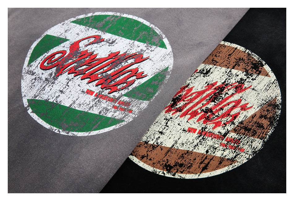 Close-up of distressed circular graphics on gray and black T-shirts.