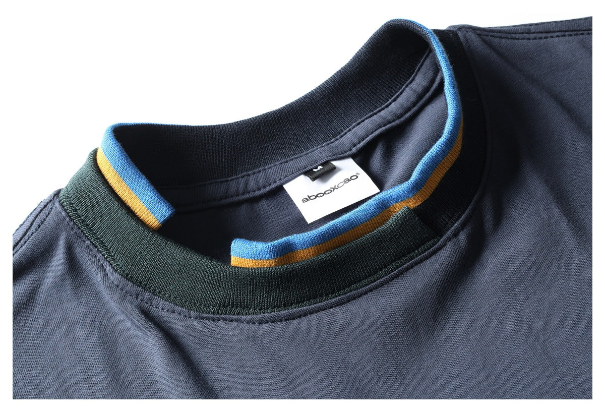 Close-up of a slate-blue shirt neckline with dark ribbing and blue and ochre striped trim.