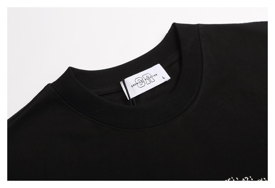 Close-up of a black T-shirt's ribbed crew neck and white interior brand and size label.
