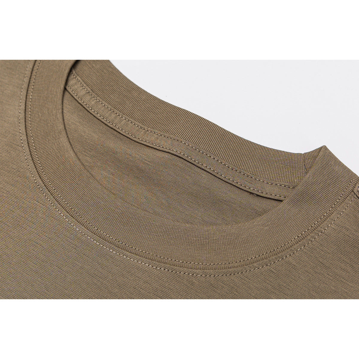 Close-up of the brown T-shirt's ribbed crew neckline and double stitching.