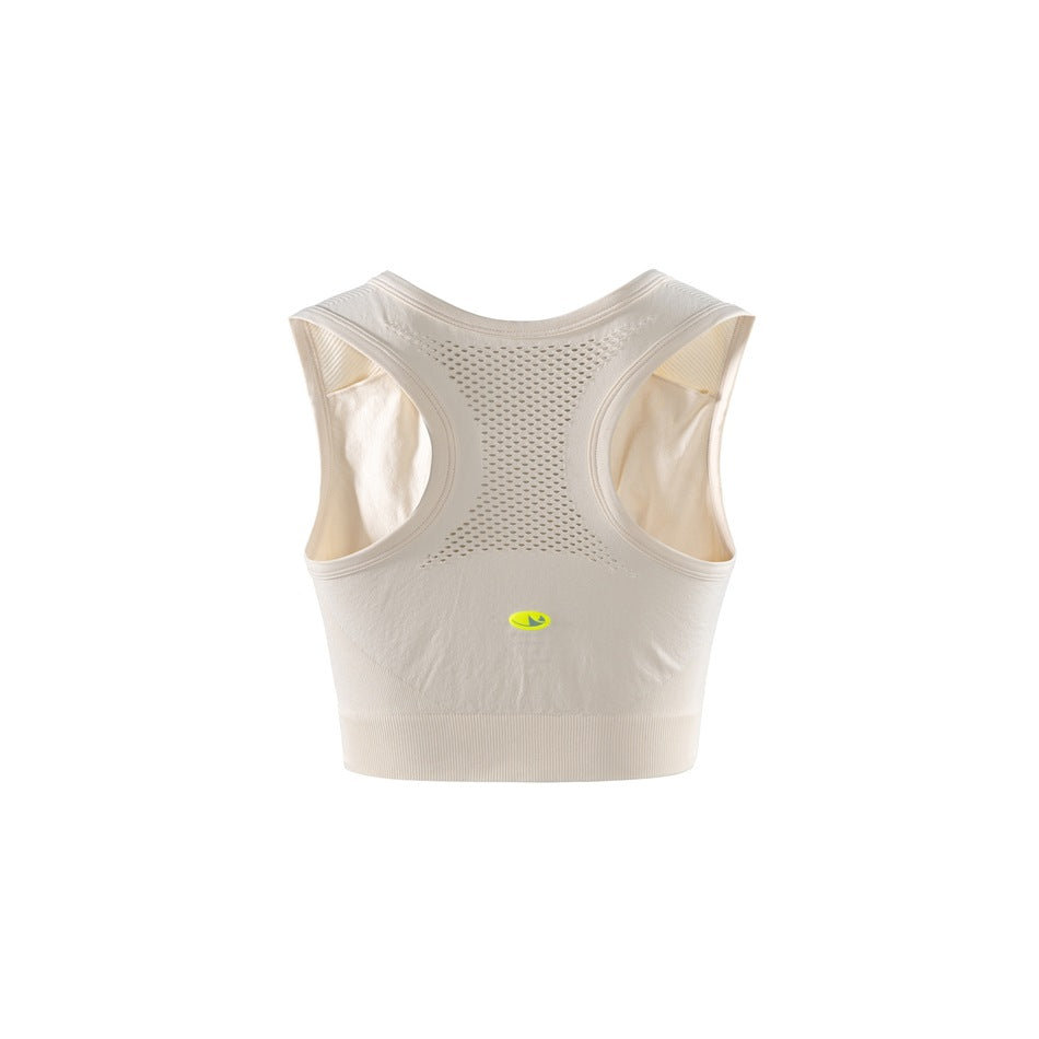 Back view of an ivory cropped sports bra with a perforated racerback panel and wide ribbed hem.