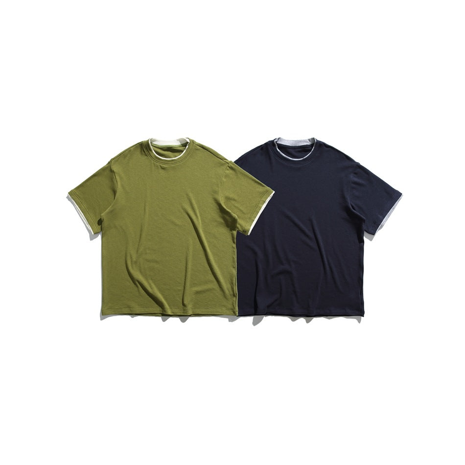 Two short-sleeve crew-neck T-shirts displayed side by side in olive green and dark navy, with light contrast trim.