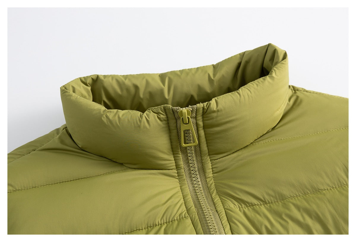 Close-up of an olive-green padded jacket's high collar, stitching, and front zipper.