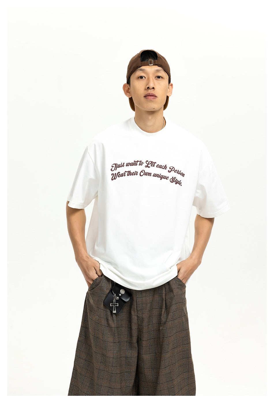 Model wearing a white short-sleeve T-shirt with burgundy script across the chest, shown from the front.
