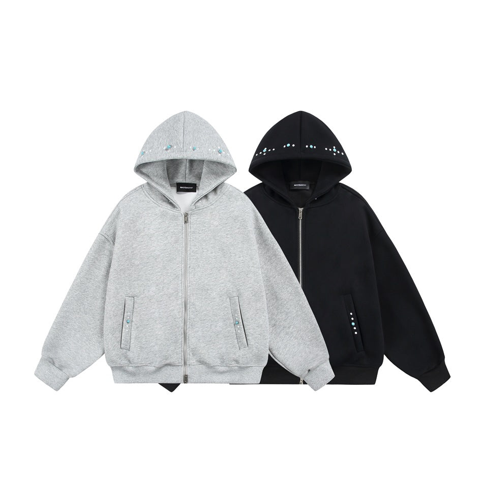 Front view of gray and black zip-up hoodies with embellished hoods, front pockets, and ribbed cuffs and hems.