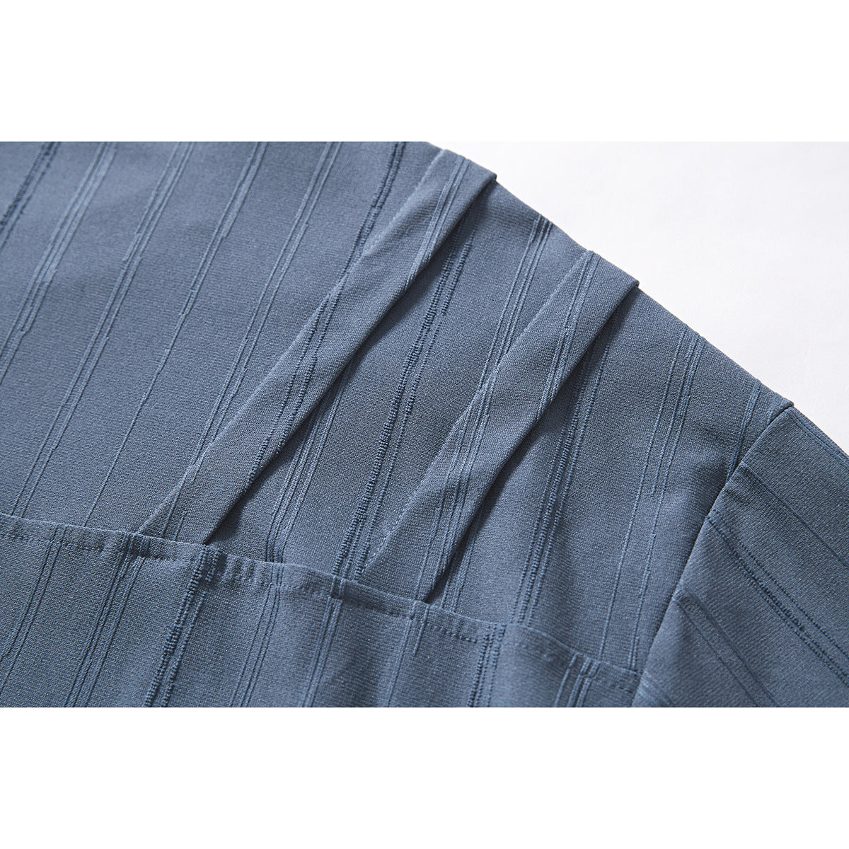 Close-up of the blue T-shirt shoulder and sleeve, showing stitched vertical stripes and seam construction.