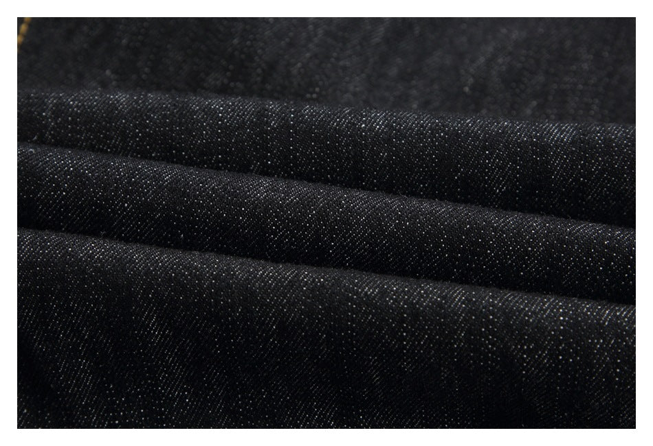 Close-up showing the dark woven texture of black denim.