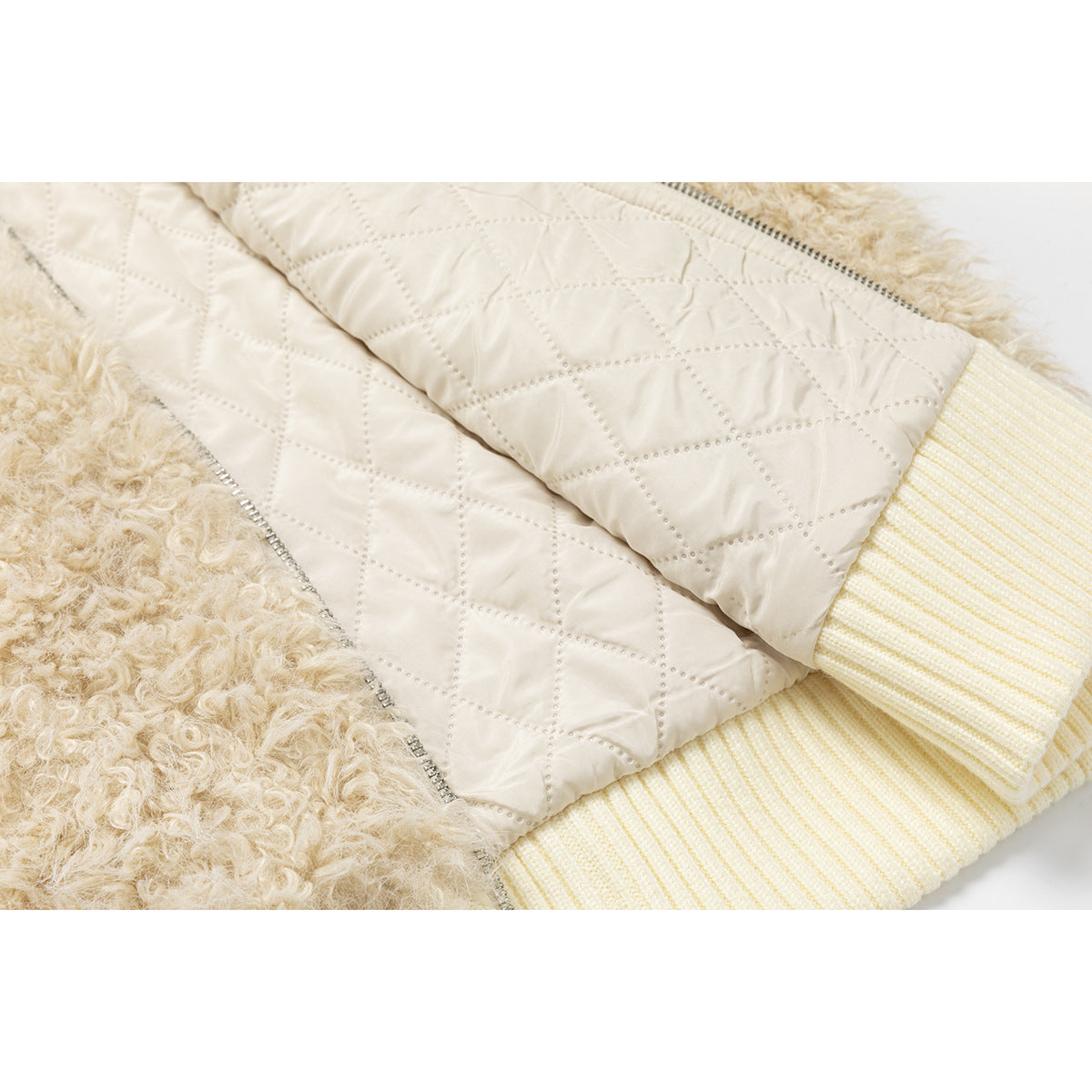 Close-up of the jacket's cream diamond-quilted lining, shaggy beige exterior and ribbed trim.