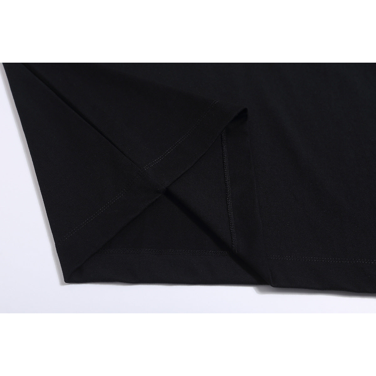 Close-up of a black T-shirt hem and inner stitching.