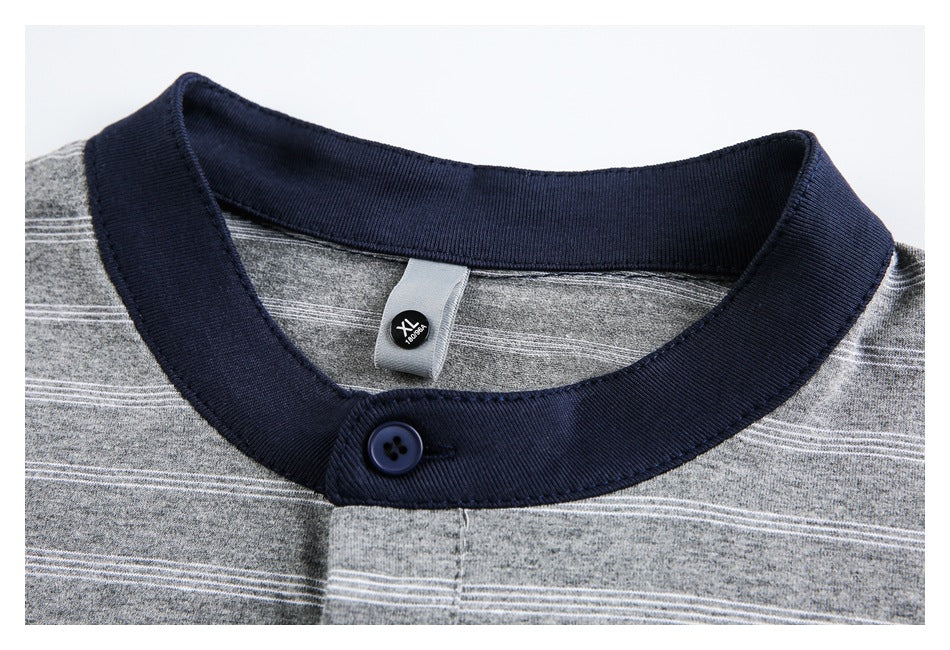 Close-up of a gray striped shirt's navy buttoned collar and inner XL size tag.