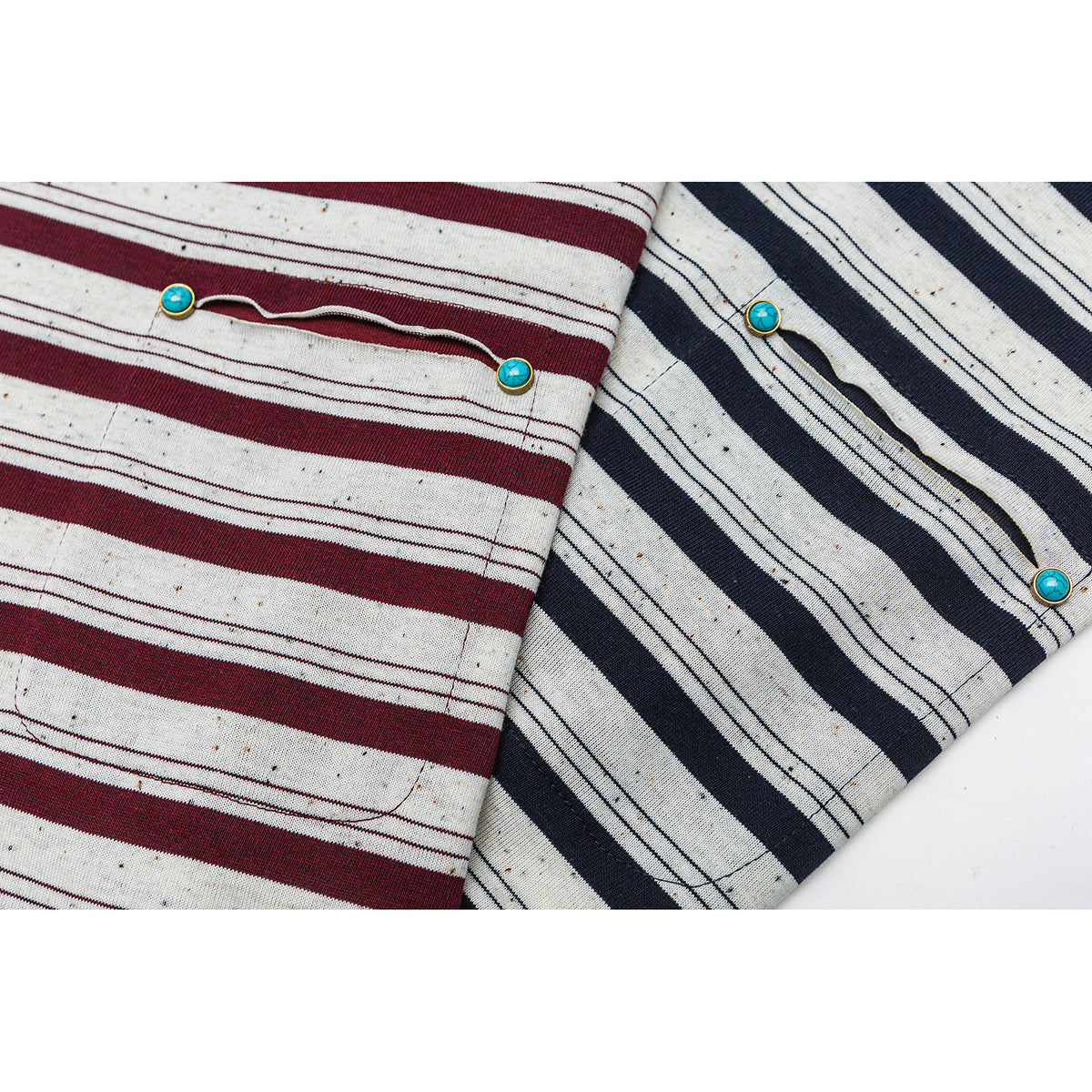Close-up of cream striped shirt pockets in burgundy and navy, each with turquoise button details.