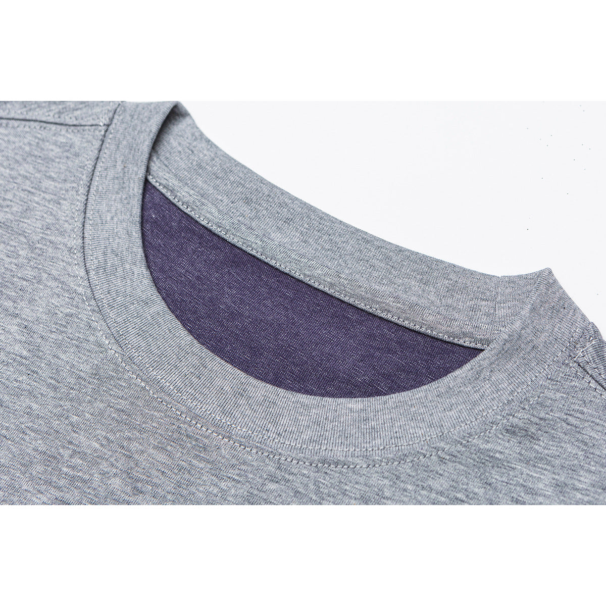 Close-up of a gray melange T-shirt's ribbed crew neckline and dark purple inner collar.