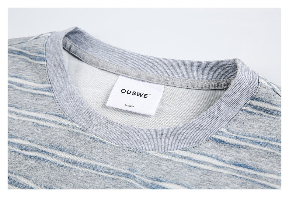 Close-up of the striped T-shirt's ribbed gray crew neck and sewn-in OUSWE label.