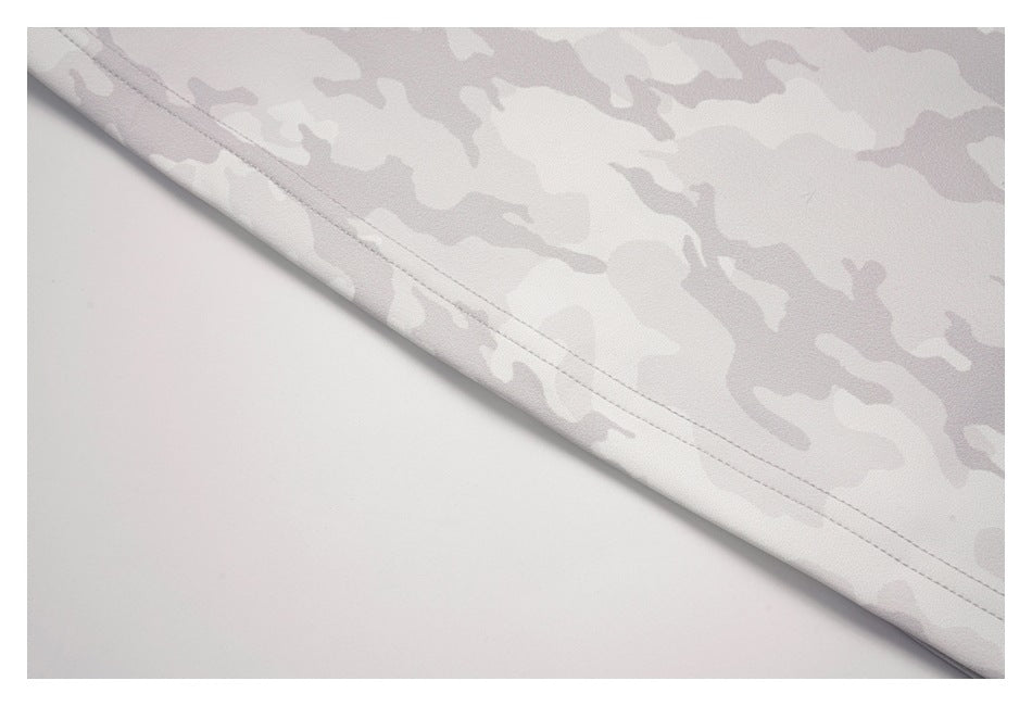 Close-up of the double-stitched hem on a pale gray camouflage garment.