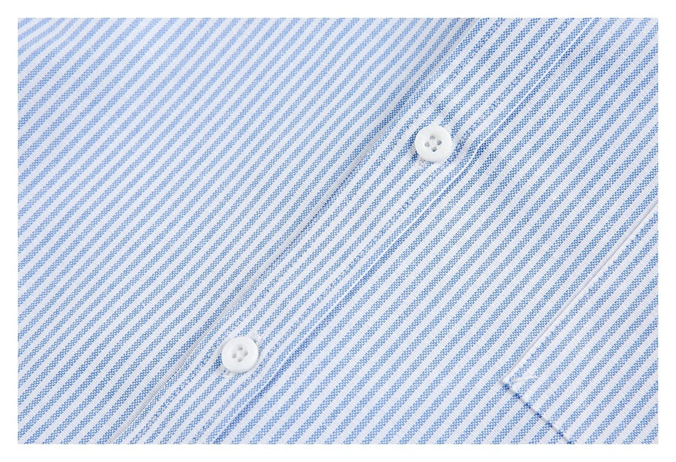 Close-up of blue-and-white diagonally striped fabric with two white buttons.
