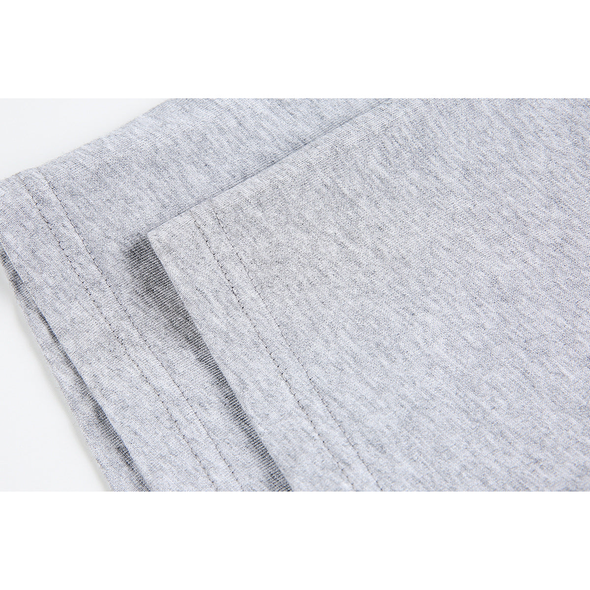Close-up of stitching and fabric on a light gray T-shirt.